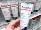 hand holding aquaphor healing ointment at target