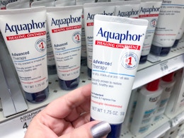 hand holding aquaphor healing ointment at target