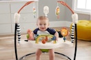 a baby in a fisher-price bouncer