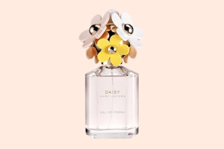 bottle of fragrance with fake flowers on top