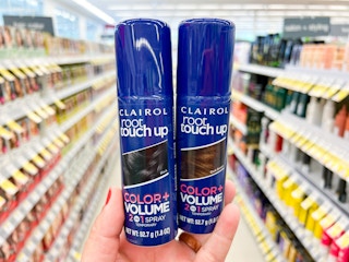 Someone holding some Clairol root touch up spray