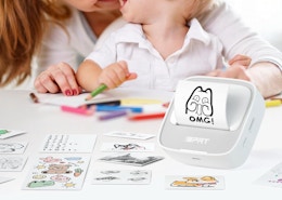 a sticker printer on a table with sticker sheets with a mom and little kid at a table