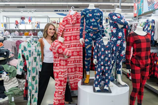 A woman posing with some onesie family pajamas in Old Navy
