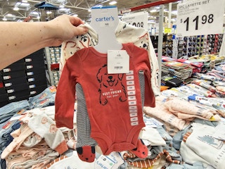 person holding a carters outfit set