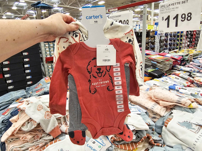 person holding a carters outfit set