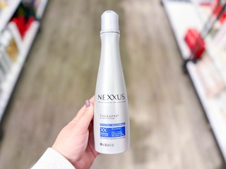 hand holding nexxus shampoo