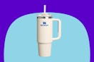 STANLEY Quencher H2.0 Tumbler with Handle and Straw 30 oz on a blue background.