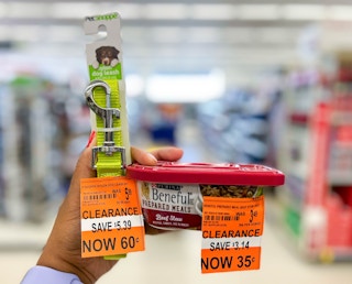 Hand holding up Nylon pet leash and container of Beneful Prepared Meals with clearance tags attached in aisle