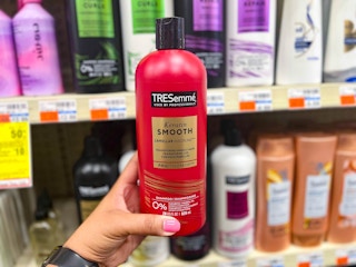 hand holding tresemme shampoo