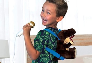 boy wearing plush backpack