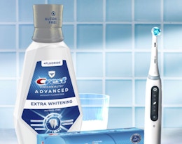 a bottle of mouthwash next to an electric toothbrush
