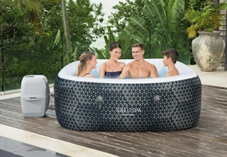 people sitting in a SaluSpa inflatable hot tub