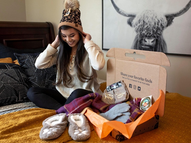 A person trying on items from their Unclaimed Baggage shipment