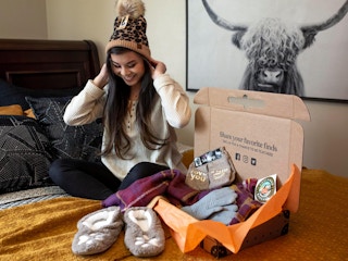 A person trying on items from their Unclaimed Baggage shipment