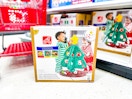 step2 christmas tree sitting on the floor in front of a target shelf and cart