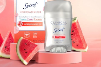 a stick of deodorant on display next to slices of watermelon 