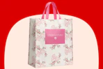 LoveShackFancy x Target tote bag in cream with a pink rose-and-bow pattern and bright pink handles