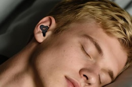 man wearing earplugs while sleeping