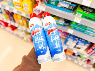 hand holding windex foam cleaner in walgreens