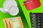 white dinnerware, wooden cutting boards, black laundry hamper, and red slow cooker
