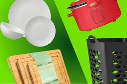 white dinnerware, wooden cutting boards, black laundry hamper, and red slow cooker