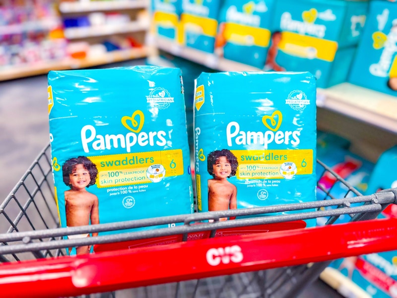 2 packages of pampers diapers in a cart