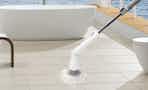 an electric floor scrubber cleaning a bathroom floor