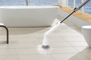 an electric floor scrubber cleaning a bathroom floor
