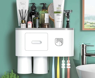 toothpaste dispenser on a green wall