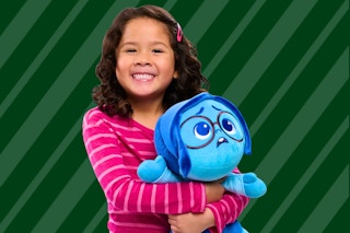 Girl holding a Sadness plush toy from Disney's Inside Out 2 Movie