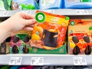 hand holding pumpkin spice air wick starter kit on walmart shelf
