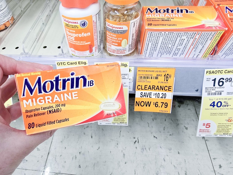 person holding a box of motrin migraine pain relief by a $6.79 clearance sign