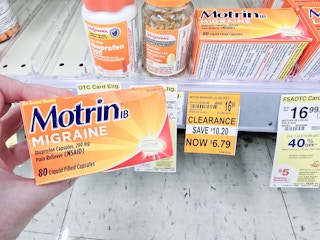 person holding a box of motrin migraine pain relief by a $6.79 clearance sign