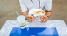 Person holding an Auntie Anne's Pretzel with a lemonade drink