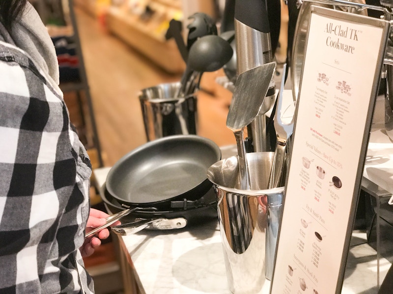 a person looking at the All-Clad section at Williams-Sonoma