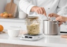 a sourdough warmer with sourdough in a jar on a kitchen counter