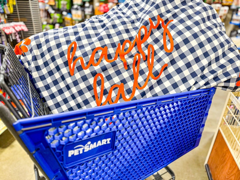 large dog bed that says happy fall in a cart