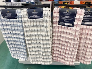 four sherpa throws hung up next to each other