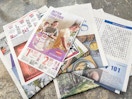 sunday newspaper laid out on table
