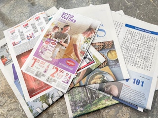 sunday newspaper laid out on table