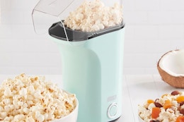 a dash popcorn maker on a table