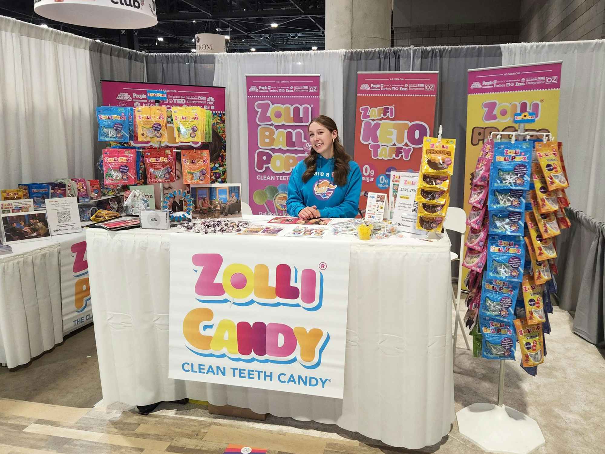 a person standing with a stand of zollicandy