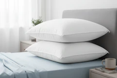 a 2-pack of gel fiber pillows on a bed 