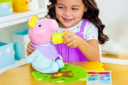 Lifestyle image of the Peppa Pig Interactive Baby Doll being played with by a child