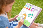 child using a water paint coloring book