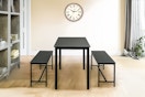 Lifestyle image of the Homestock 3-piece dining set (in the color black) 