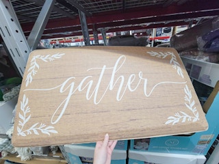 farmhouse style anti fatigue kitchen mat, it's brown and says gather