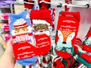 hand holding wondershop cozy socks in front of socks at target
