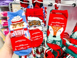 hand holding wondershop cozy socks in front of socks at target