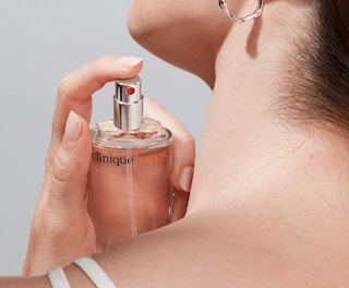 a person spraying on perfume